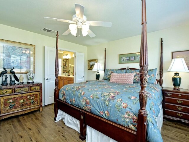 bedroom featuring connected bathroom, dark hardwood / wood-style floors, and ceiling fan