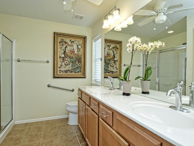 bathroom with vanity, toilet, and a shower with shower door