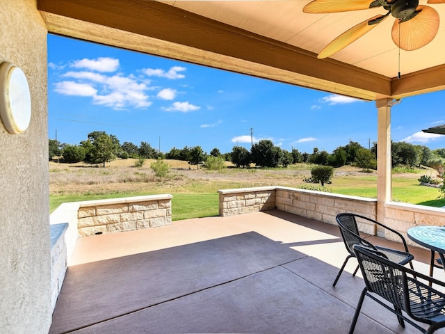 view of patio featuring a rural view and ceiling fan