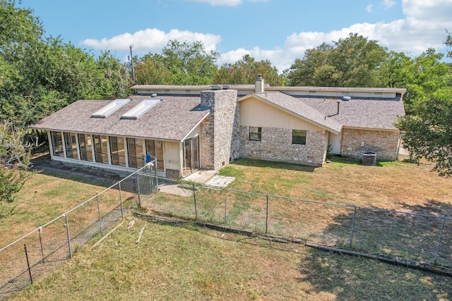 rear view of house featuring a yard