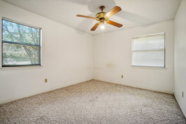 unfurnished room with ceiling fan, a textured ceiling, and carpet floors