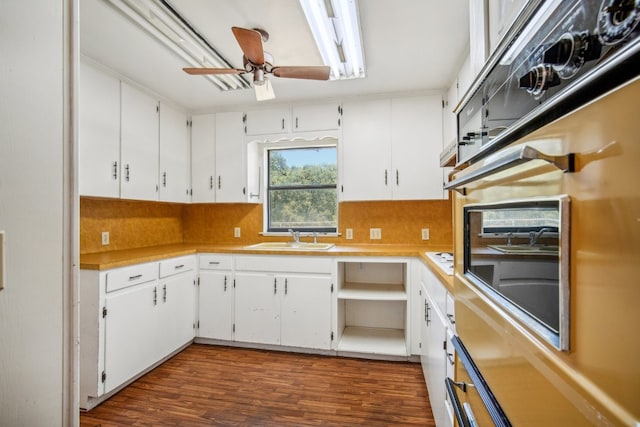 kitchen featuring ceiling fan, dark wood-type flooring, and white cabinetry