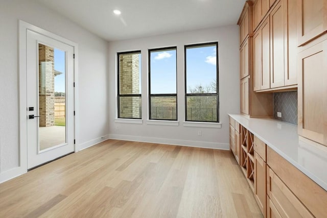 interior space with plenty of natural light and light hardwood / wood-style floors