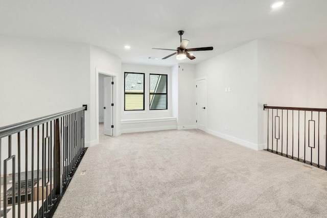 empty room featuring ceiling fan and light carpet