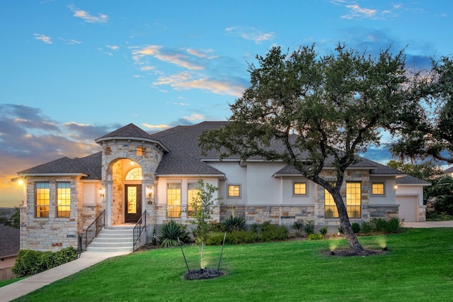 view of front of property featuring a garage and a yard