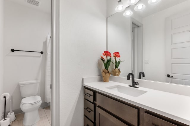 bathroom with tile patterned flooring, curtained shower, vanity, and toilet