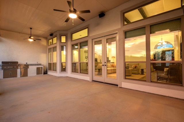 view of patio with ceiling fan, french doors, a grill, and exterior kitchen