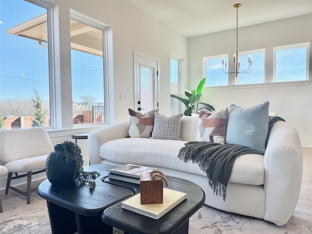 living room with a chandelier and light hardwood / wood-style flooring