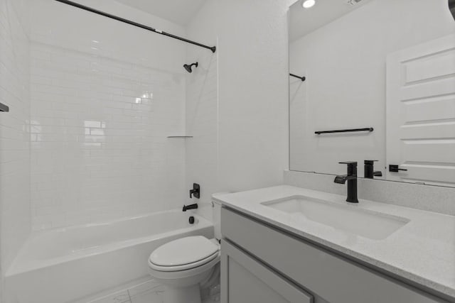 full bathroom with vanity, tiled shower / bath combo, and toilet