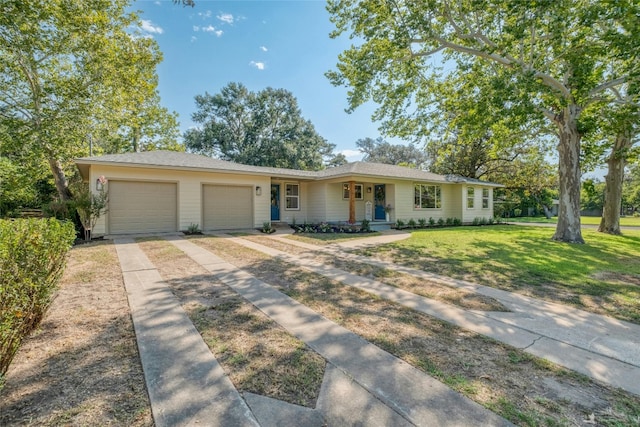 single story home with a porch, a front yard, and a garage