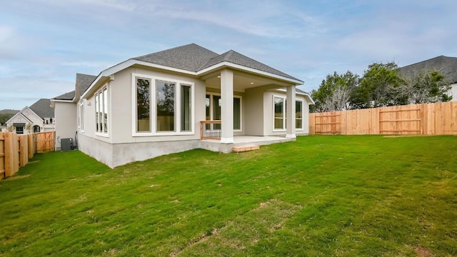 back of house with a yard, central AC, and a patio area