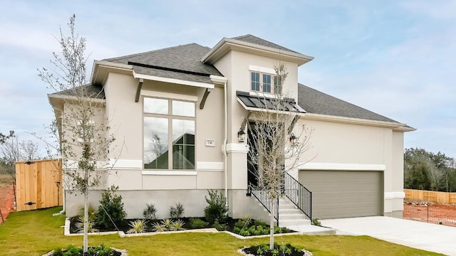 view of front facade with a garage and a front lawn