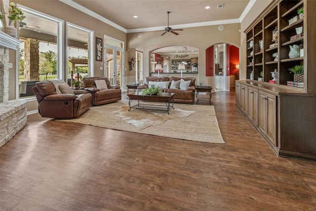 living room with ornamental molding, a fireplace, dark hardwood / wood-style floors, and ceiling fan