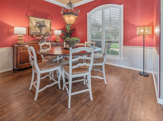 dining room featuring crown molding and hardwood / wood-style flooring