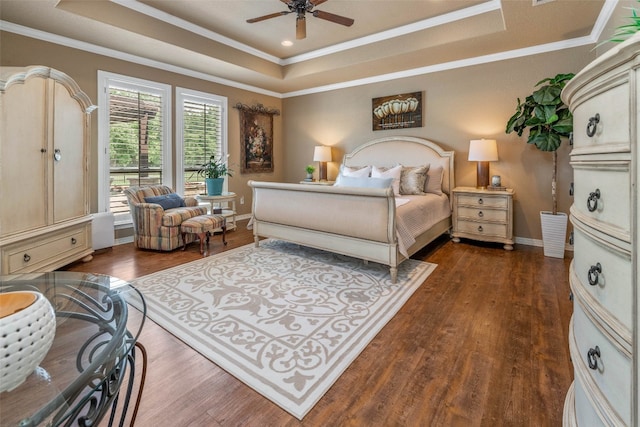 bedroom featuring dark hardwood / wood-style flooring, a raised ceiling, and ceiling fan