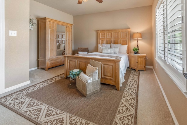 bedroom with ceiling fan and light carpet