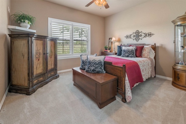 bedroom with ceiling fan and light colored carpet