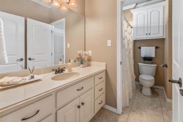 bathroom featuring toilet, vanity, and tile patterned flooring