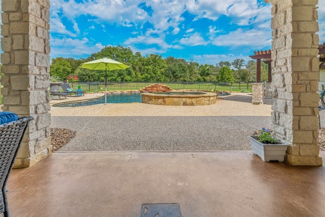 view of patio / terrace with an in ground hot tub