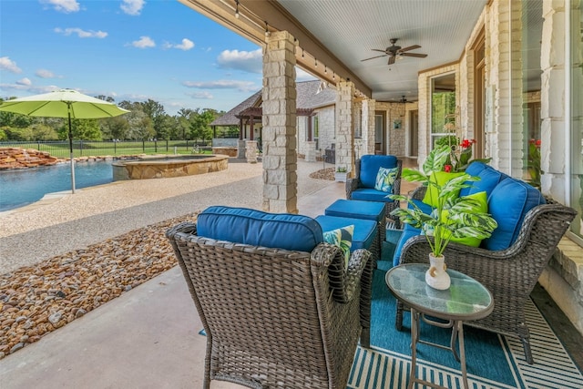 view of patio featuring an outdoor living space, a pool with hot tub, and ceiling fan