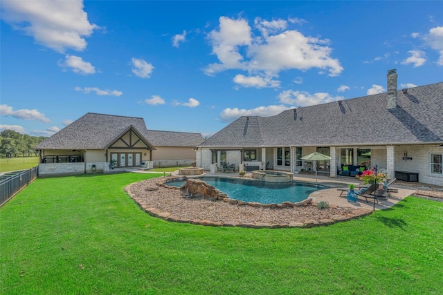 view of swimming pool with a patio, french doors, and a lawn