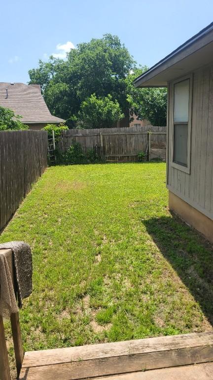 view of yard with a fenced backyard