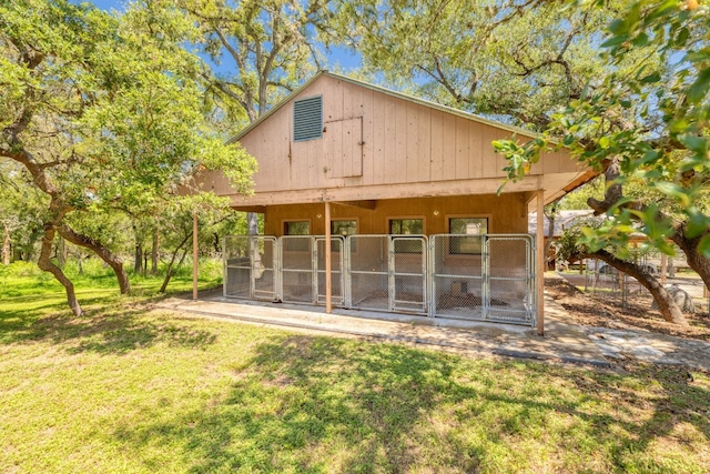 rear view of property featuring an outdoor structure