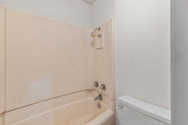 bathroom with toilet and shower / tub combination