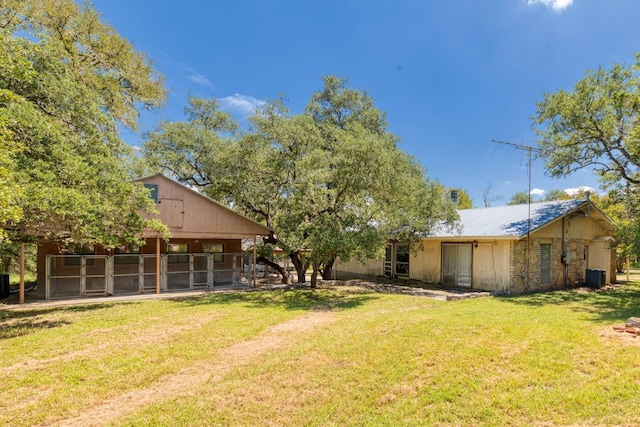 view of yard featuring an outbuilding and central air condition unit
