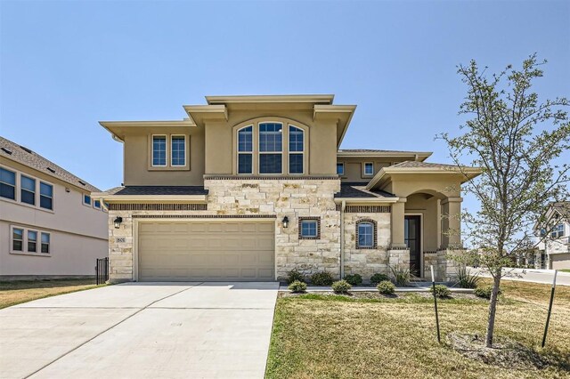 view of front of house featuring a garage and a front lawn