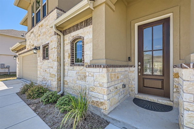 view of exterior entry with a garage