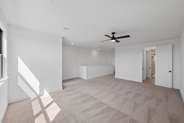 empty room featuring light carpet and ceiling fan