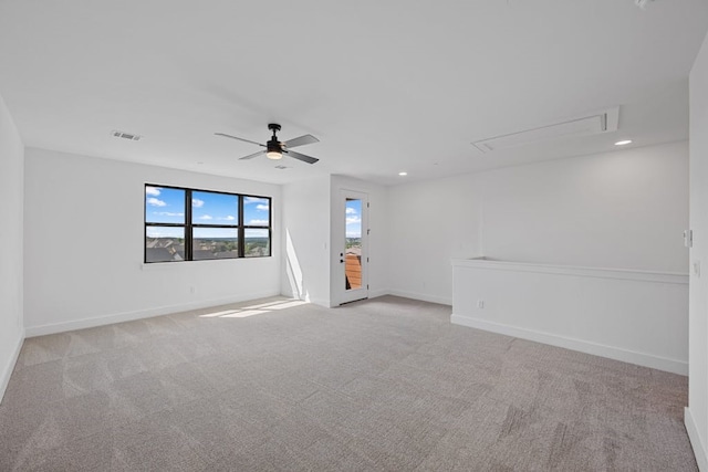 carpeted spare room with ceiling fan