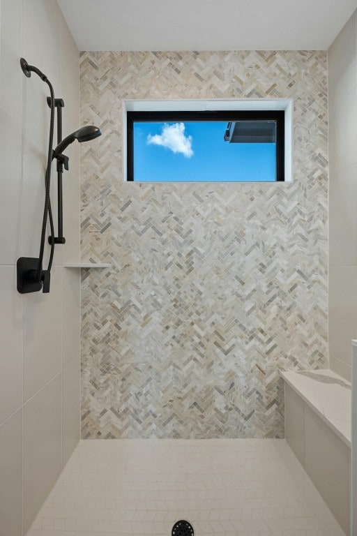 bathroom with a tile shower