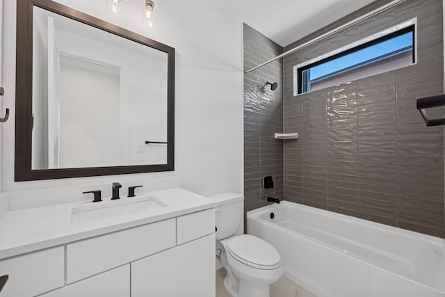 full bathroom featuring toilet, vanity, and tiled shower / bath