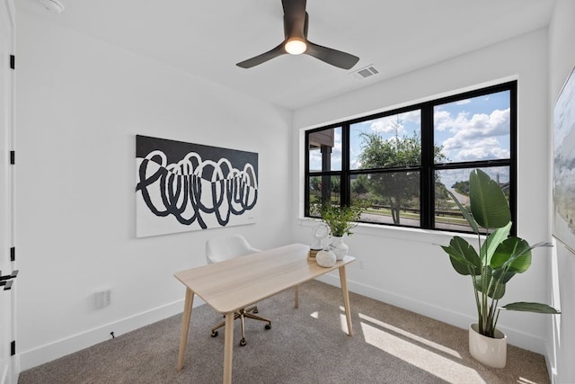 carpeted office with ceiling fan