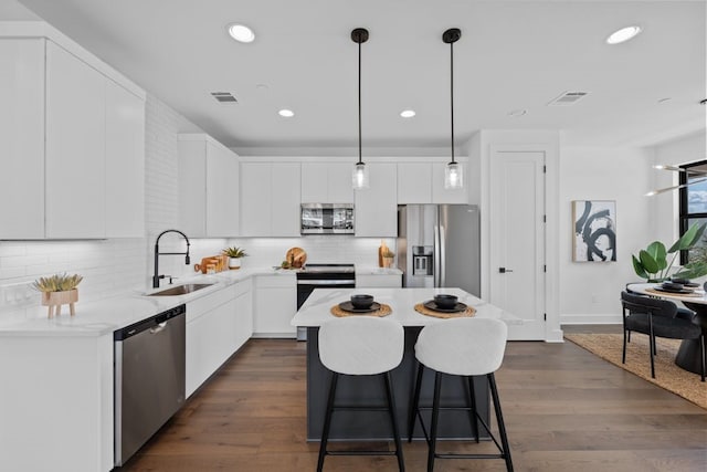 kitchen featuring stainless steel appliances, white cabinetry, dark hardwood / wood-style floors, and sink