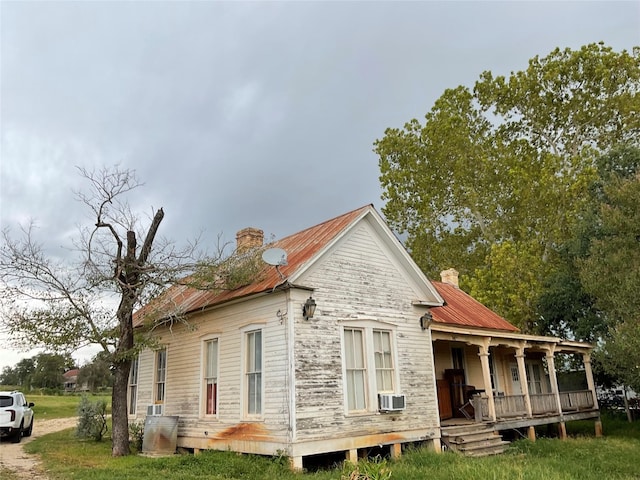 back of property featuring covered porch and cooling unit