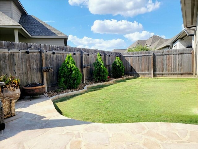 242 Freeman Loop, Liberty Hill, TX 78642 - fenced backyard featuring a patio