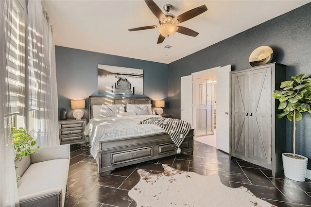 bedroom featuring ensuite bathroom and ceiling fan