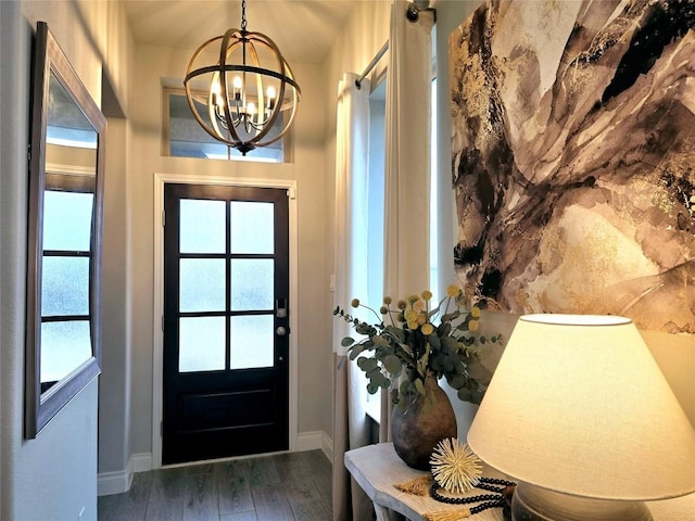 foyer entrance featuring dark hardwood / wood-style floors and an inviting chandelier