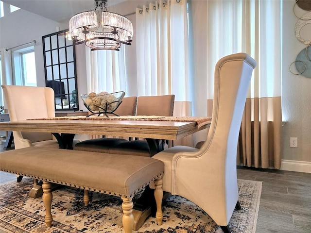 dining area with a chandelier and wood-type flooring