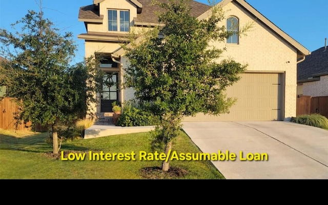 242 Freeman Loop, Liberty Hill, TX 78642 - view of front of property featuring driveway, stucco siding, and an attached garage