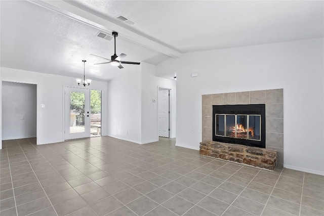 unfurnished living room featuring ceiling fan with notable chandelier, light tile patterned floors, lofted ceiling with beams, and a textured ceiling