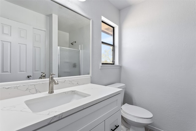 bathroom with vanity, an enclosed shower, and toilet