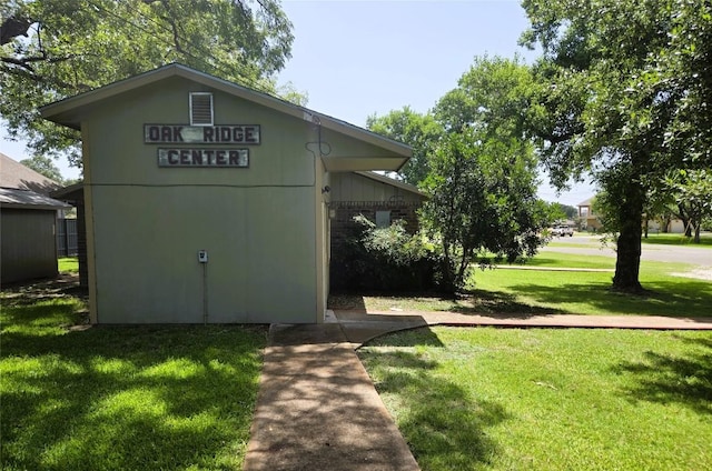 view of side of home with a lawn