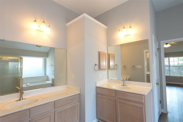 bathroom featuring ceiling fan, vanity, independent shower and bath, and hardwood / wood-style floors