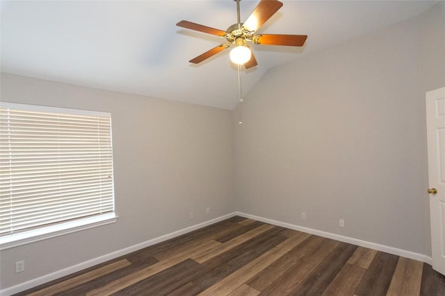 unfurnished room with dark hardwood / wood-style flooring, vaulted ceiling, and ceiling fan