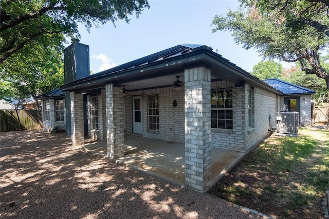 view of property exterior with a patio, cooling unit, and ceiling fan