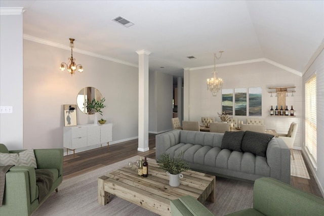 living room with crown molding, vaulted ceiling, decorative columns, and a chandelier